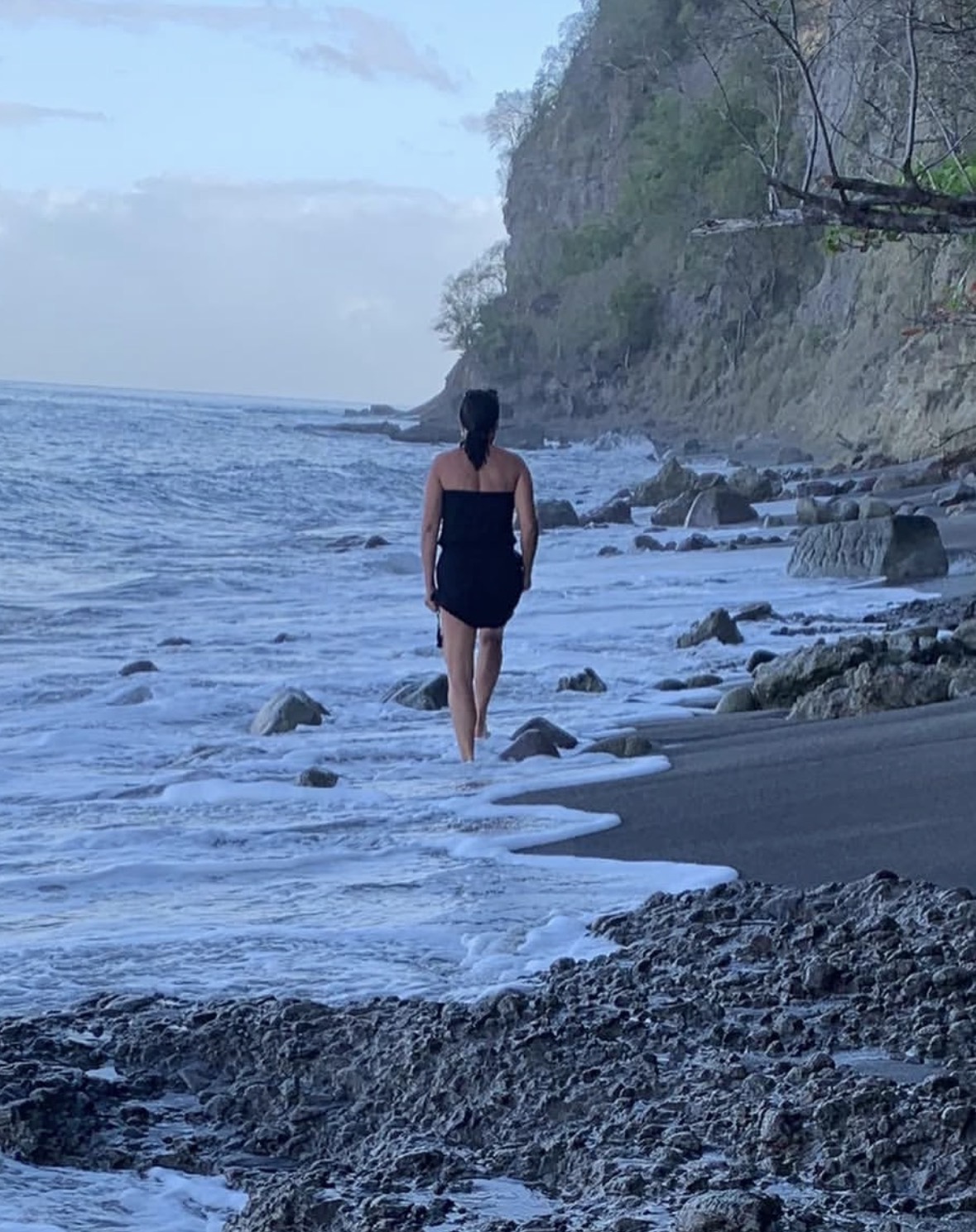 Viviane walking along the ocean shore